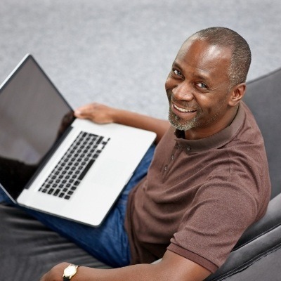 A middle-aged man looking at his new smile